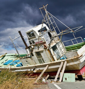 Abandoned fishing boat on Iwate coast symbolizes maritime community challenges in Japan.