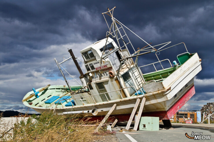 Abandoned fishing boat on Iwate coast symbolizes maritime community challenges in Japan.