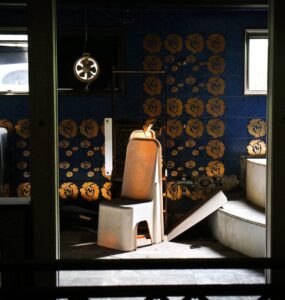 Elegant blue and gold interior design with geometric shapes and moody lighting.