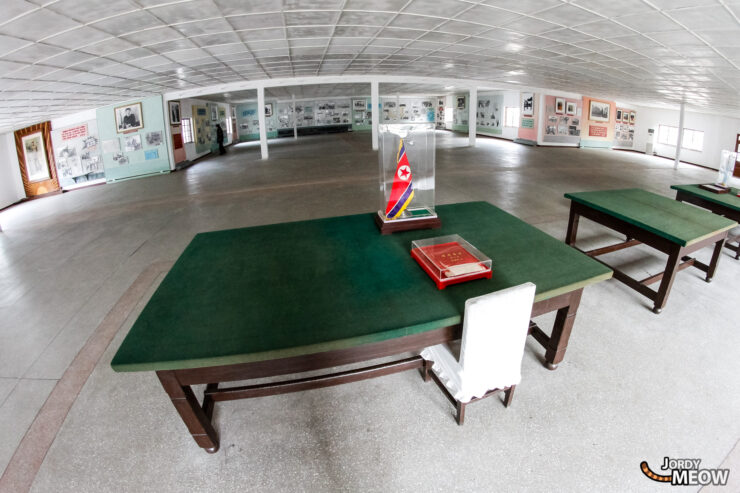 Explore North Korean cultural exhibition with historical artifacts and recreational pool tables in a functional setting.