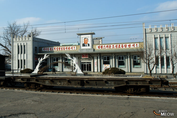 Exploring North Korea: Unique train station with political portrait, aged infrastructure, and wintry surroundings.