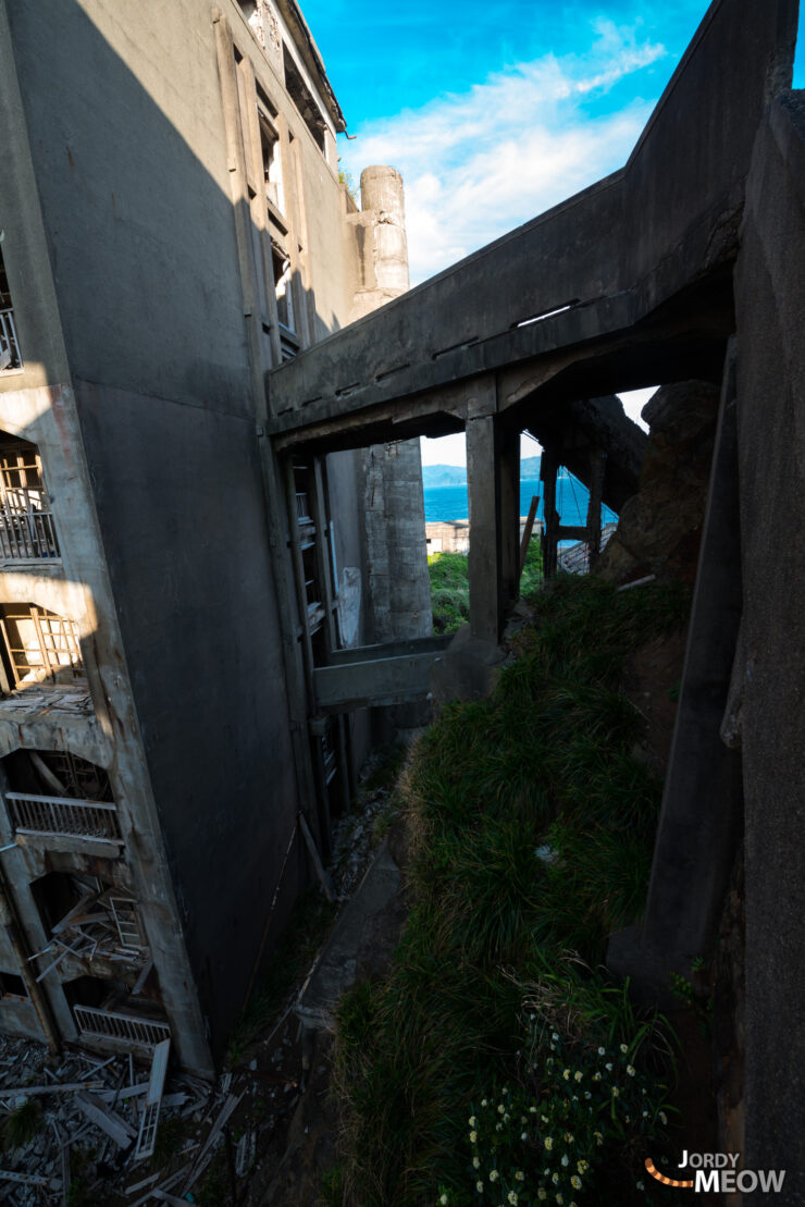 Abandoned Gunkanjima footbridge: haunting remnants of industrial decline in Nagasaki, Japan.
