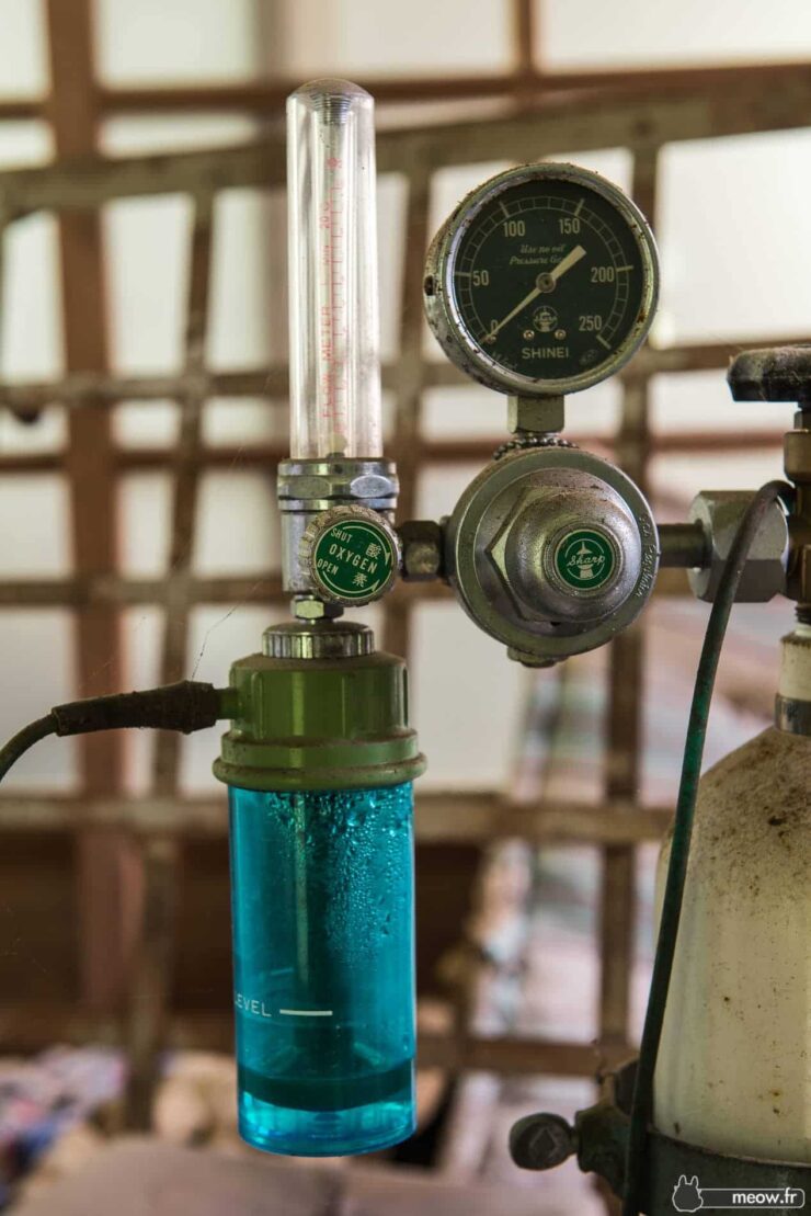 Gas regulator with control knob and gauge in industrial workshop for welding or metalworking.