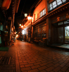 Discover the enchanting alleyways of historic Shibu Onsen, Japan, filled with lantern-lit wooden buildings.