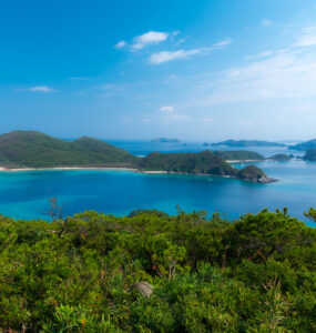 Tranquil view of Okinawas lush bay with turquoise waters and rugged islands.