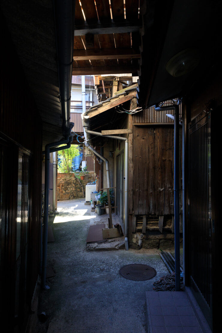 Exploring quaint alleys in historic Tomonoura, Japan - a picturesque, timeless experience.