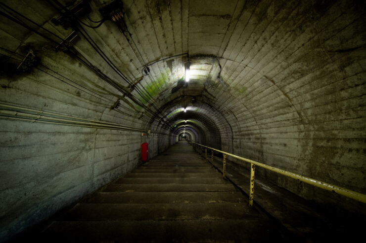 Gloomy subterranean passageway, abandoned infrastructure.