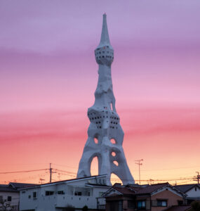 Imposing war memorial tower against sunset skyline.