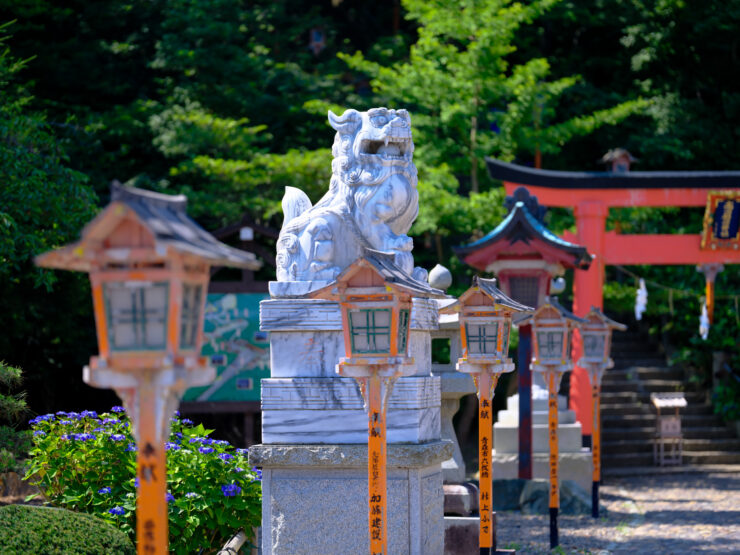 Tranquil Japanese Inari Shrine Amid Lush Forest Setting