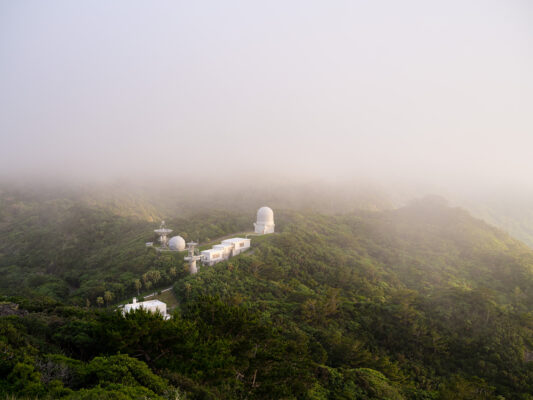 Serene foggy mountain with observatory domes