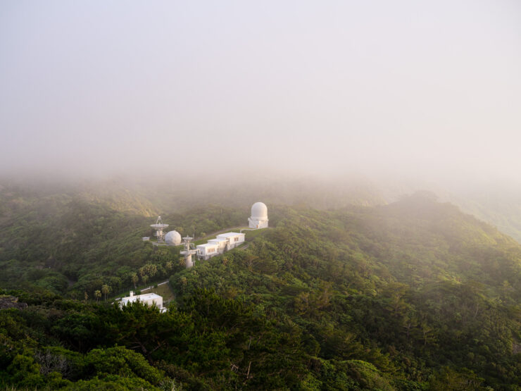 Serene foggy mountain with observatory domes